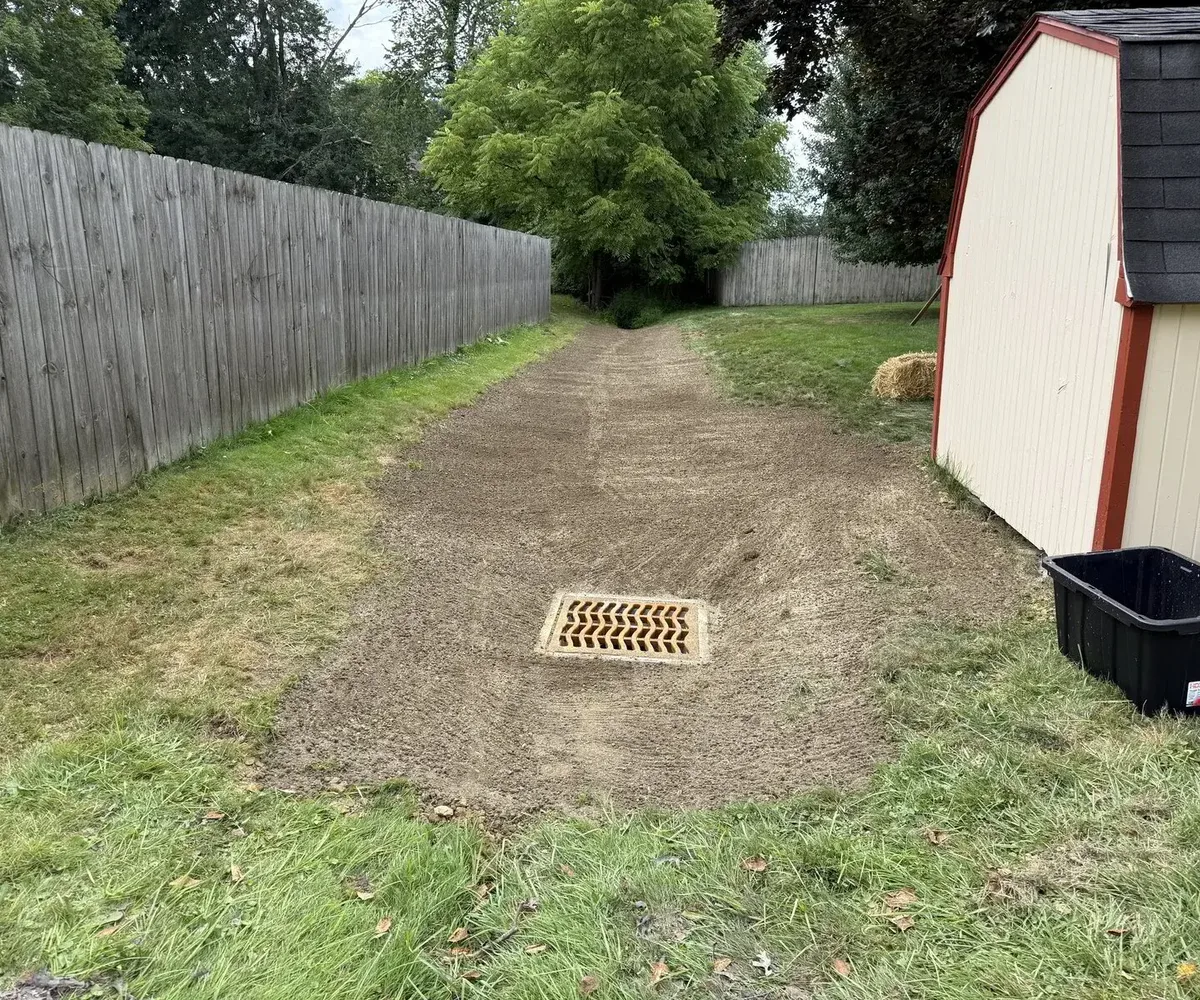 Finished yard drain and regraded swale after drainage work
